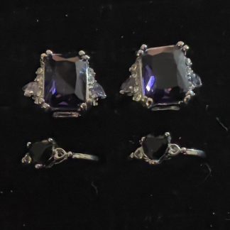 Two sets of rings - a large silvery, rectangular Amethyst ring, alongside two Onyx Black Heart rings with silvery bands.